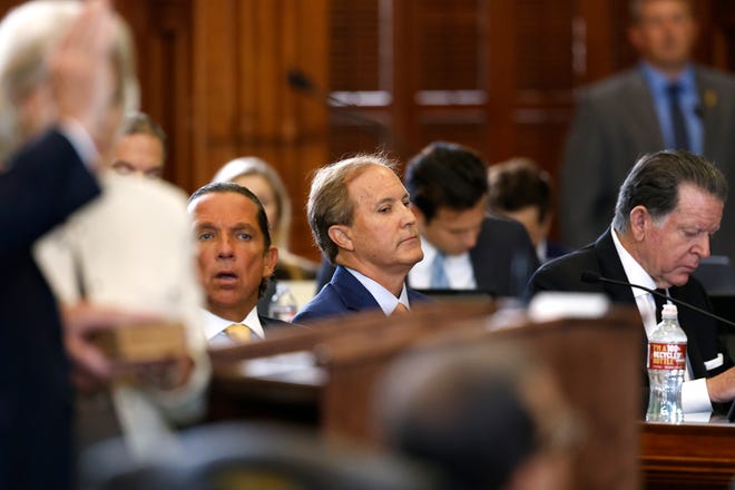 Texas Attorney General Ken Paxton (center) sits next to attorneys Tony Buzbee (center left) and Dan Cogdell (right) as Texas Sen. Robert Nichols (left), R-Jacksonville, is sworn in during the first day of Paxton’s impeachment trial in the Texas Senate chambers at the Texas State Capitol in Austin on Tuesday, Sept. 5, 2023. The Texas House, including a majority of its GOP members, voted to impeach Paxton for alleged corruption in May. (Juan Figueroa/Pool via The Dallas Morning News)