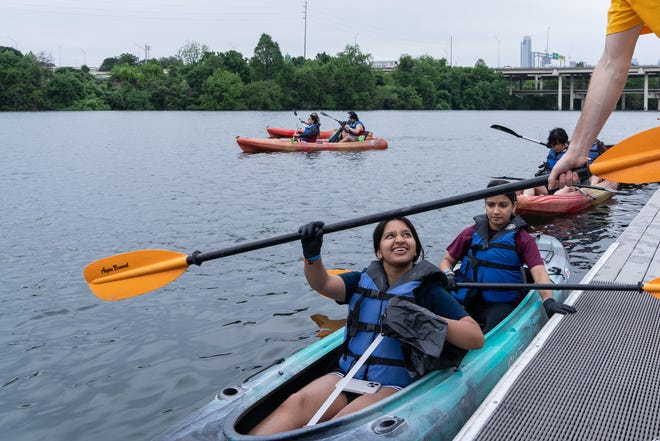 Rutvi Kunadi and Janhavi Singh take off in a kayak from the Rowing Dock to clean up trash in Lady Bird Lake for Earth Day Cleanup for The Trail Conservancy on Friday, April 19, 2024. Volunteers spent the day cleaning up Butler Hike-and-Bike Trail and Lady Bird Lake.