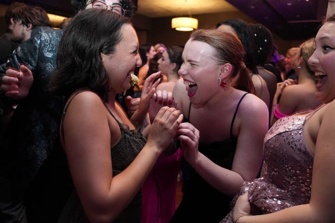 Grace Nelson, left, and Ava Moak, right, laugh on the dance floor at the Round Rock High School Prom at the Sheraton Austin and Georgetown hotel on Saturday, April 27, 2024 in Georgetown, Texas.